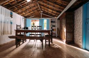 a dining room with a wooden table and chairs at Vila Luz in Caraíva