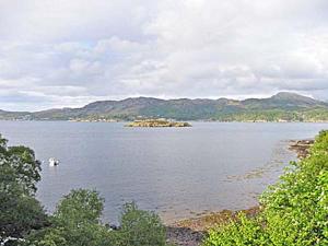 a large body of water with mountains in the background at Camus Na Harry in Shieldaig