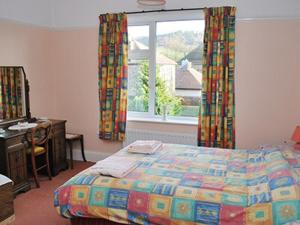 a bedroom with a bed and a window at Melville in Bakewell