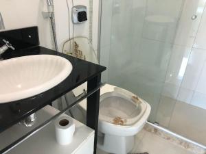 a bathroom with a sink and a toilet and a shower at FORTE DA PRAIA in Cabo Frio +5 photos
