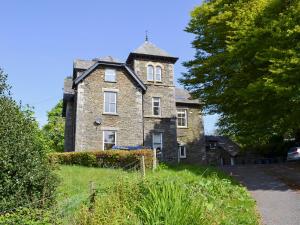 an old brick building with a tower on top of it at 4 The Old Vicarage in Far Sawrey