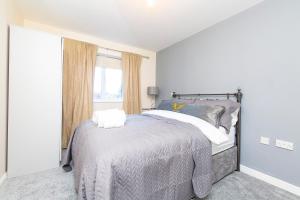 a white bedroom with a bed and a window at Durham 2-Bed Apartment in Leamside