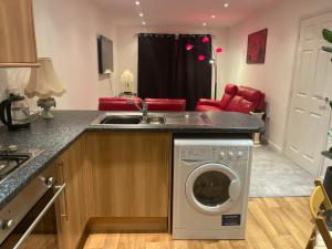 a kitchen with a washing machine and a sink at Durham 2-Bed Apartment in Leamside