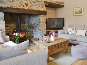 a living room with a couch and a fireplace at Llifon in Llanwnda