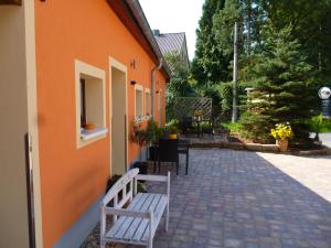 a white bench sitting next to a building at Pension Stettin in Stadt Wehlen