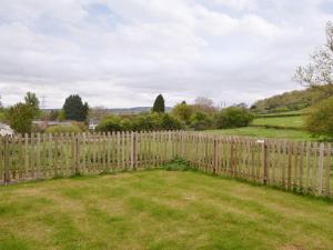 a wooden fence with a field behind it at Barley House - RFFN in Fownhope