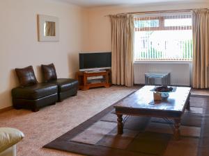 a living room with a couch and a coffee table at Riverside in Annan