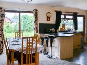 a kitchen with a table and a dining room at Riverside in Annan