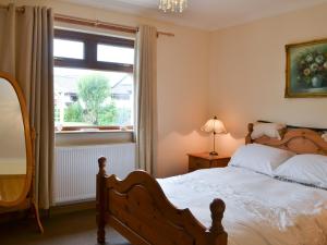a bedroom with a bed and a window at Riverside in Annan
