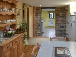 a kitchen with a table and a dining room at Ladycroft Barn in Bamford