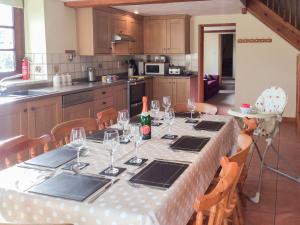 a kitchen with a table with wine glasses on it at The Pump House in Hawkesbury