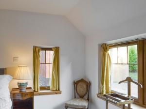 a bedroom with a sink and a chair next to a window at Shedend in Kingston