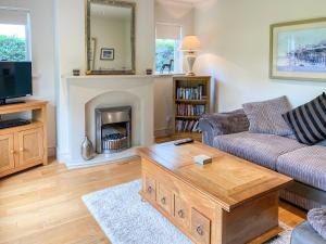 a living room with a couch and a coffee table at Storrs Croft in Arkholme