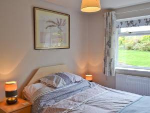 a bedroom with a bed and a window at Woodview Lodge in Barlow