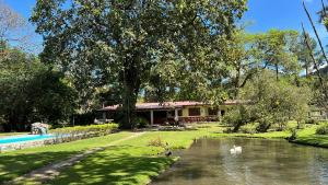 a house next to a river with ducks in it at La Casa de los Patos in Valle de Anton