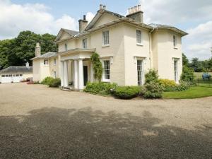 a large white house with a large driveway at The Old Rectory Lodge in Yaxham