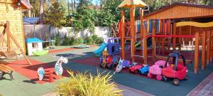 a playground with a toy train on a slide at Ośrodek 9Amber in Pobierowo