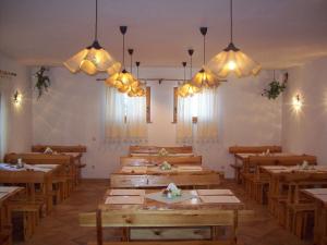 a dining room with wooden tables and chandeliers at Villa Confort Exclusive in Rovinj