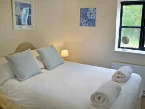 a bedroom with a white bed with towels on it at Pond-b6844 in Sedghill