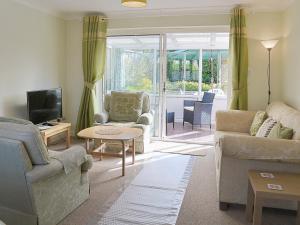 a living room with two couches and a tv at Corney Grain in Teversham