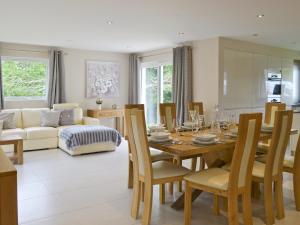 a dining room and living room with a table and chairs at Honey Pippin in Cheriton Bishop