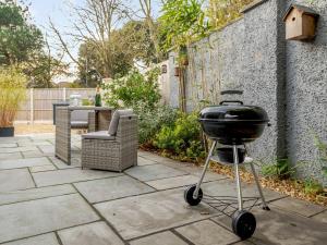 a grill on a stand on a patio at Solsken in Bournemouth