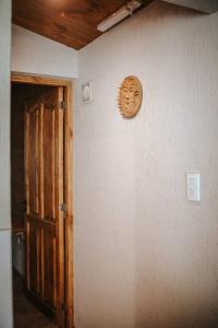 a mask on a wall next to a door at Posada Los Cipreses in San Rafael