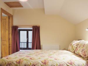 a bedroom with a bed and a window at Nuthatch - 29363 in Ifton Heath