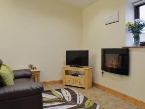 a living room with a flat screen tv and a couch at Nuthatch - 29363 in Ifton Heath