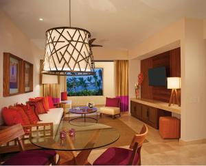 a living room with a couch and a table at Secrets Akumal Riviera Maya - Adults Only in Akumal