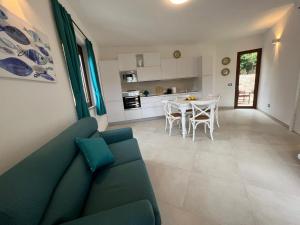 a living room with a couch and a table at Isolotto Guest House in Porto Ercole