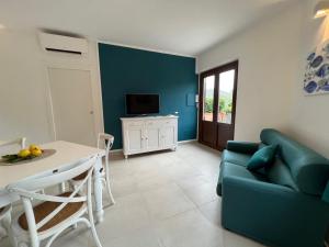 a living room with a couch and a table at Isolotto Guest House in Porto Ercole