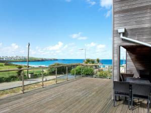 a wooden deck with a view of the ocean at Fistral View - 3 Cribbar in Newquay