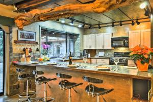 a kitchen with a large wooden bar with stools at Willamette Valley Apt - Surrounded by Wineries! in Newberg