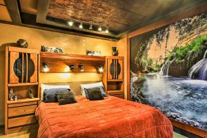 a bedroom with a large bed with a painting on the wall at Willamette Valley Apt - Surrounded by Wineries! in Newberg