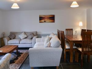 a living room with a couch and a table at Tower House in Ambleside