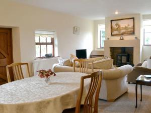 a living room with a table and a fireplace at Stublick View in Langley