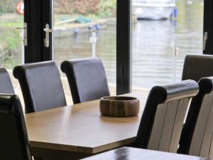a table with chairs and a bowl on top of it at Caracol - Cccf in Wroxham