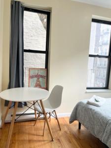 a room with a table and a bed and a window at Budget Single Room Near Central Park in New York