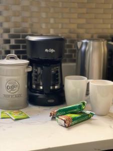 a counter with a coffee maker and two cups on it at Budget Single Room Near Central Park in New York