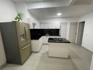 a large kitchen with a stainless steel refrigerator at Casa Campestre Girardot in Girardot