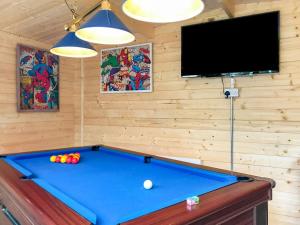 a pool table in a room with a tv at Green Haven in Narberth