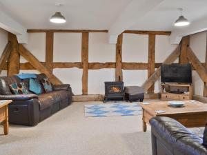 a living room with a couch and a stove at The Olde Granary - E4298 in Halston