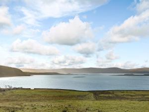 a large body of water with mountains in the background at 3 Breckery in Staffin