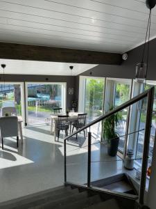 a living room with a staircase and a table and chairs at Nygård Camping in Hjelle