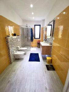 a large bathroom with two sinks and two toilets at Casa Angelica (Pizzo, Tropea, Lamezia) in Maida