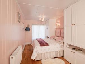 a small bedroom with a bed and a window at Dunultach Cottage in Ronachan