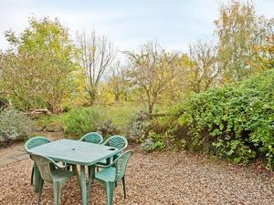 a table and chairs sitting on top of a gravel yard at The Pightl - 17627 in Castle Acre