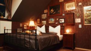 a bedroom with a bed and many pictures on the wall at ANKER in Arneburg