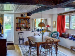 a dining room with a table and chairs at Driftcombe Farmhouse in Bisley